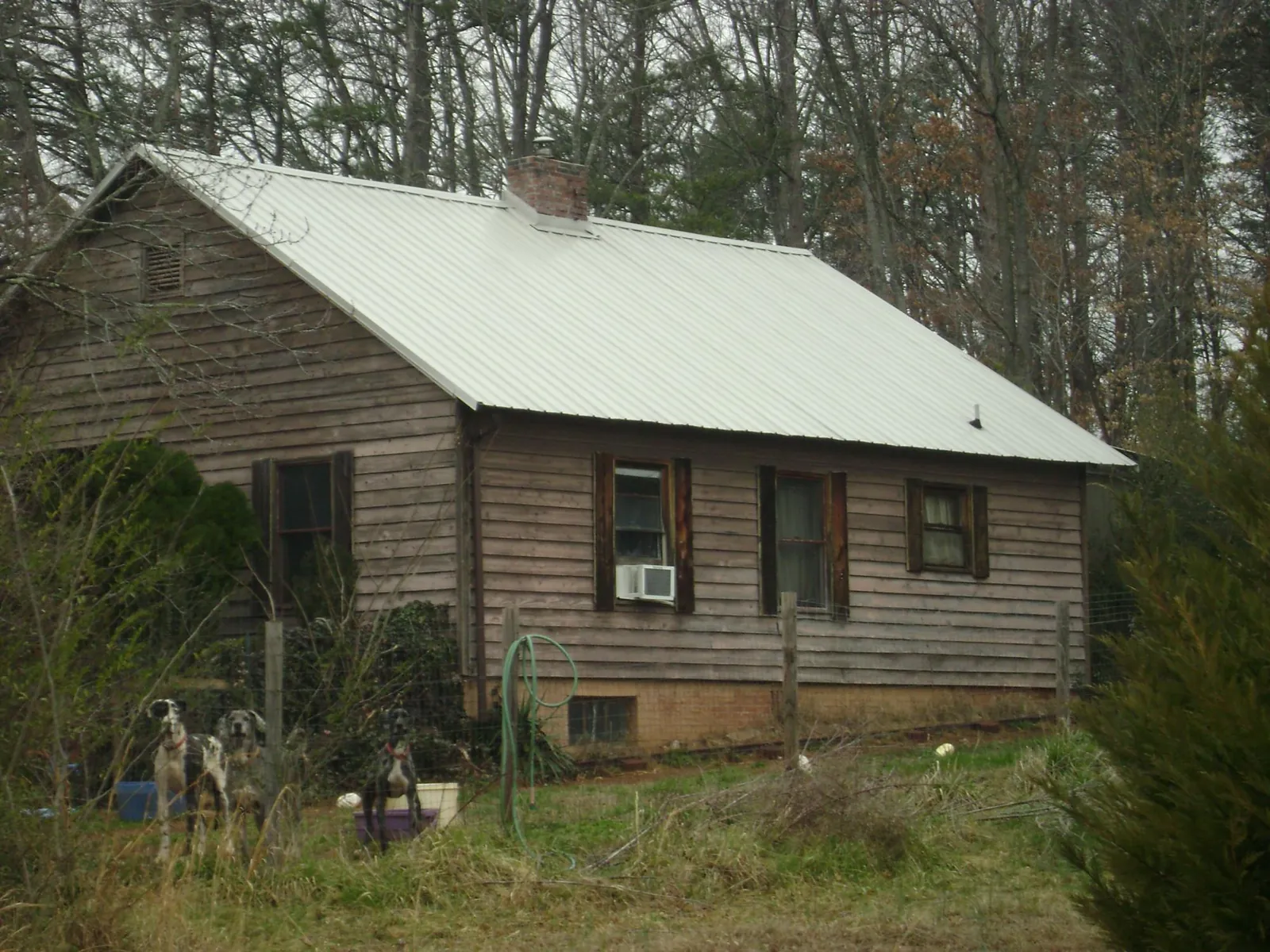 White metal roof on an old wood sided farmhouse, from a Metal Roof Installation job in West College Corner